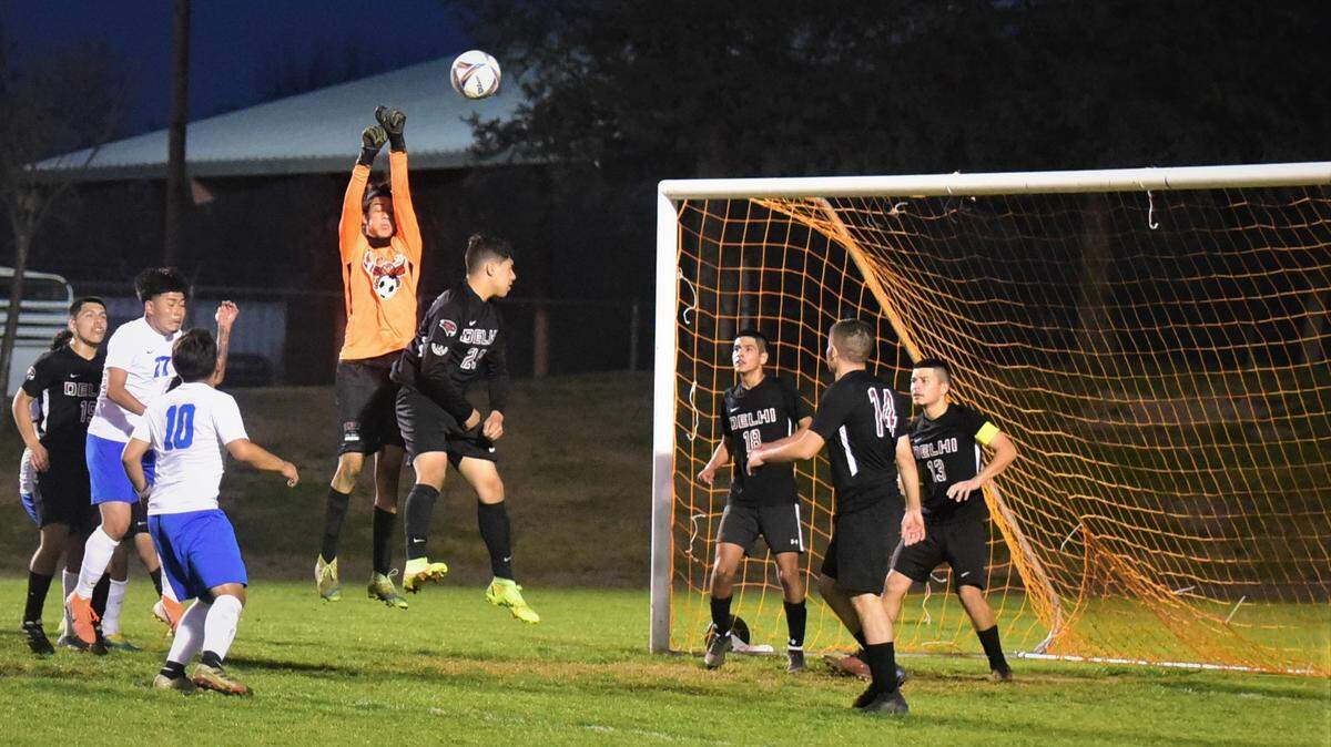 Delhi goalie Roberto Moreno goes up to deflect a corner kick against King City during a Northern California Regional Playoff match on Tuesday, March 1, 2022 at Delhi High School in Delhi, Calif.