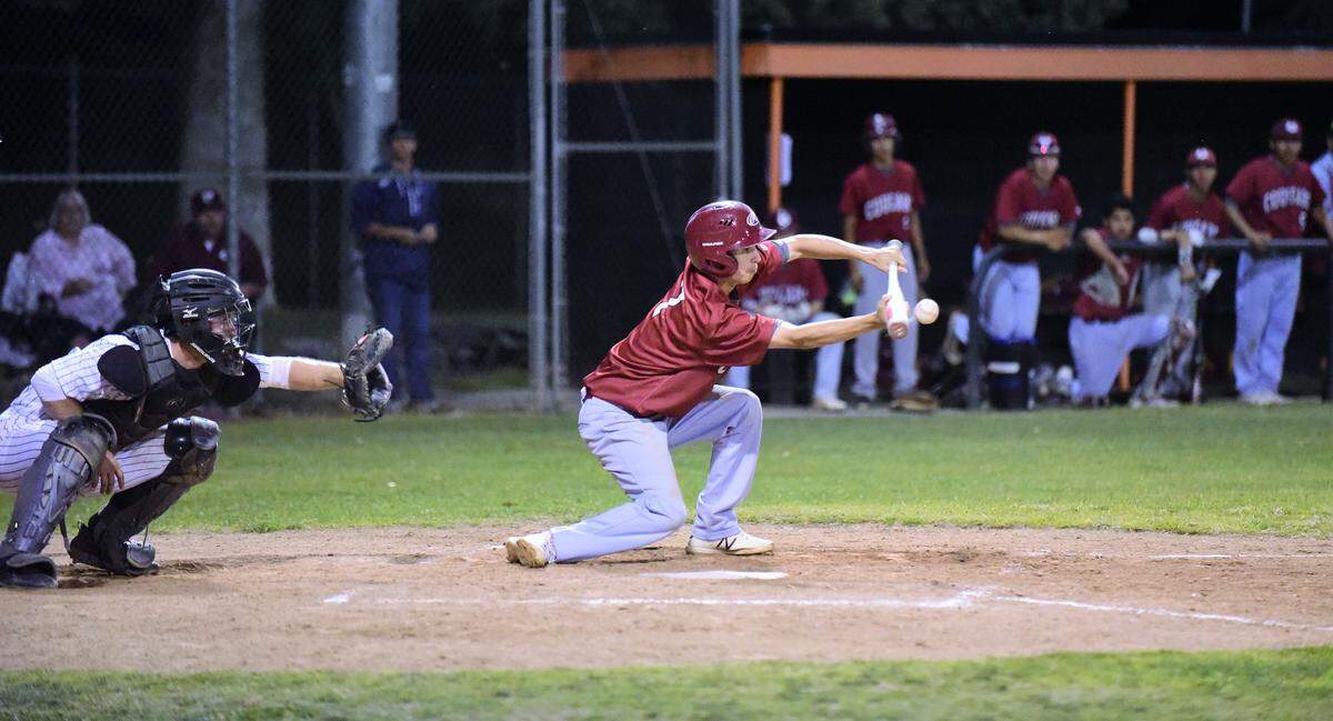 Golden Valley senior Robert White lays down a squeeze bunt to drive in the winning run in the seventh inning of the Cougars’ 2-1 win over Merced on Friday, May 3, 2019.