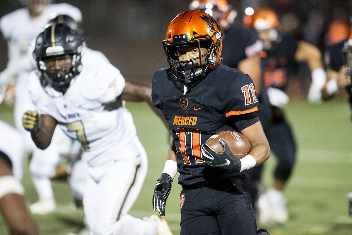 Merced junior Desmond Thompson (11) rushes for a large gain during a game against Buhach Colony at Veterans Stadium in Merced, Calif., on Friday, Oct. 5, 2018. The Bears beat the Thunder 55-14.