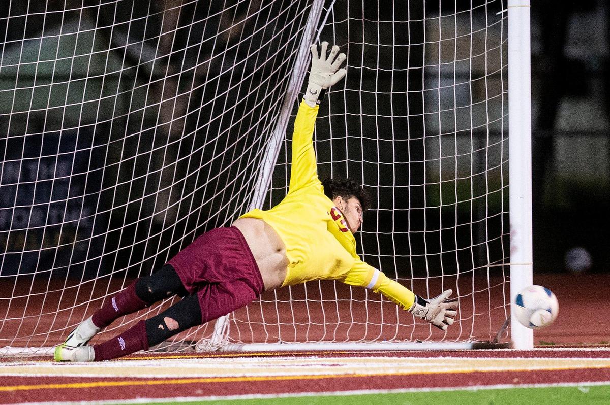 Golden Valley senior goalkeeper Manuel Zarco Zarate attempts to save a Las Lomas penalty kick during a NorCal Regional playoff game at Golden Valley High School in Merced, Calif., on Tuesday, Feb. 27, 2024. The Knights beat the Cougars 3-1 in penalty kicks.