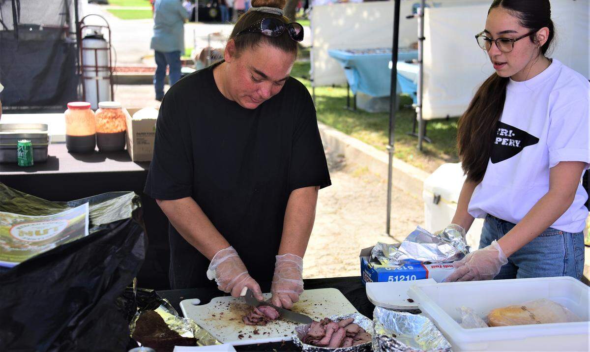 Sarah Richardson of Balico, slices tri-tip at the Tri-Tipery booth at the Merced County Nut Festival on Saturday, Oct. 22, 2022 at the Merced County Fairgrounds.
