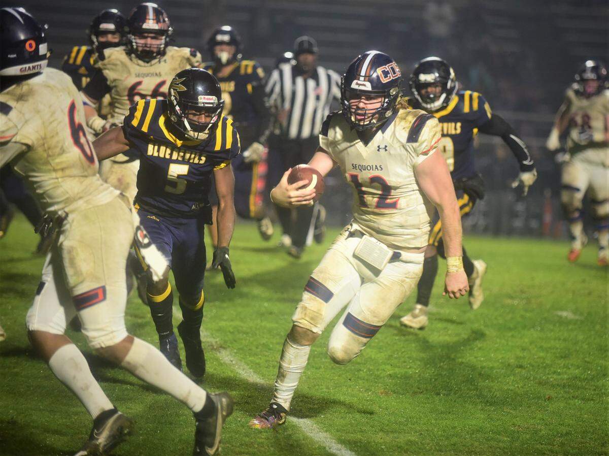 College of Sequoias quarterback Nathan Lamb runs the ball against Merced College during the Valley Center Bowl game on Thursday, Dec. 2, 2021 at Merced College.