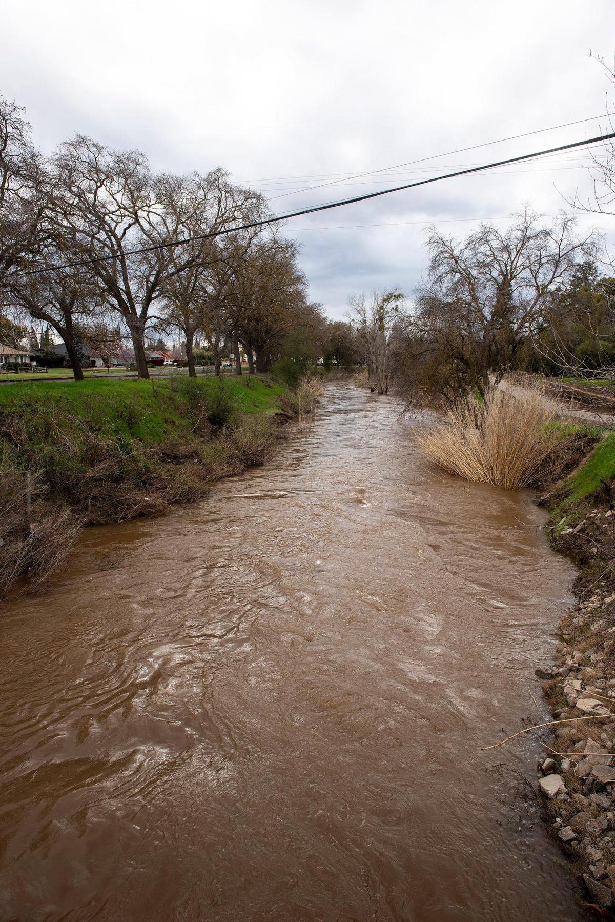 Bear Creek flows past McKee Road in Merced, Calif., on Sunday, March 12, 2023.