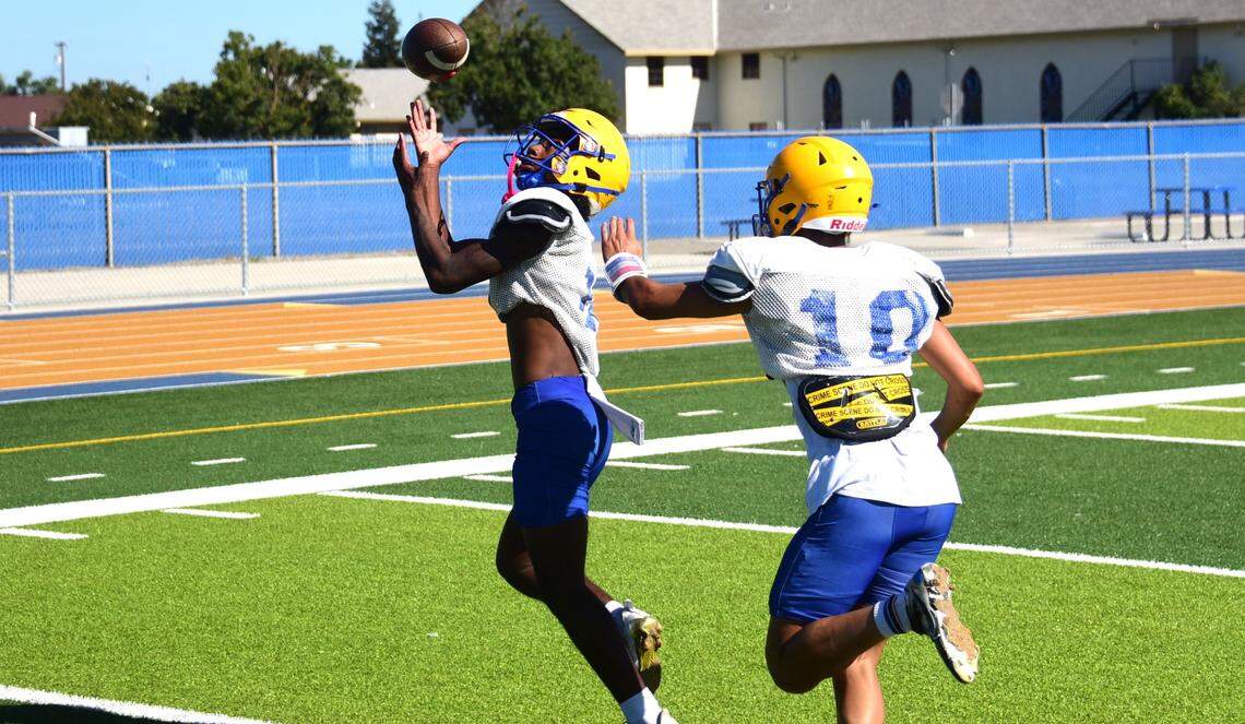Dos Palos High School senior Jacquez Jones (12) hauls in a pass during practice on Tuesday, Aug. 13, 2024.