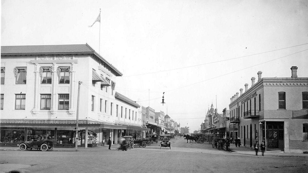 Looking east on Main Street near M Street, Merced, circa 1910s. During this time, it was a common and sometimes chaotic scene of horses and cars traveling and sharing the same road.