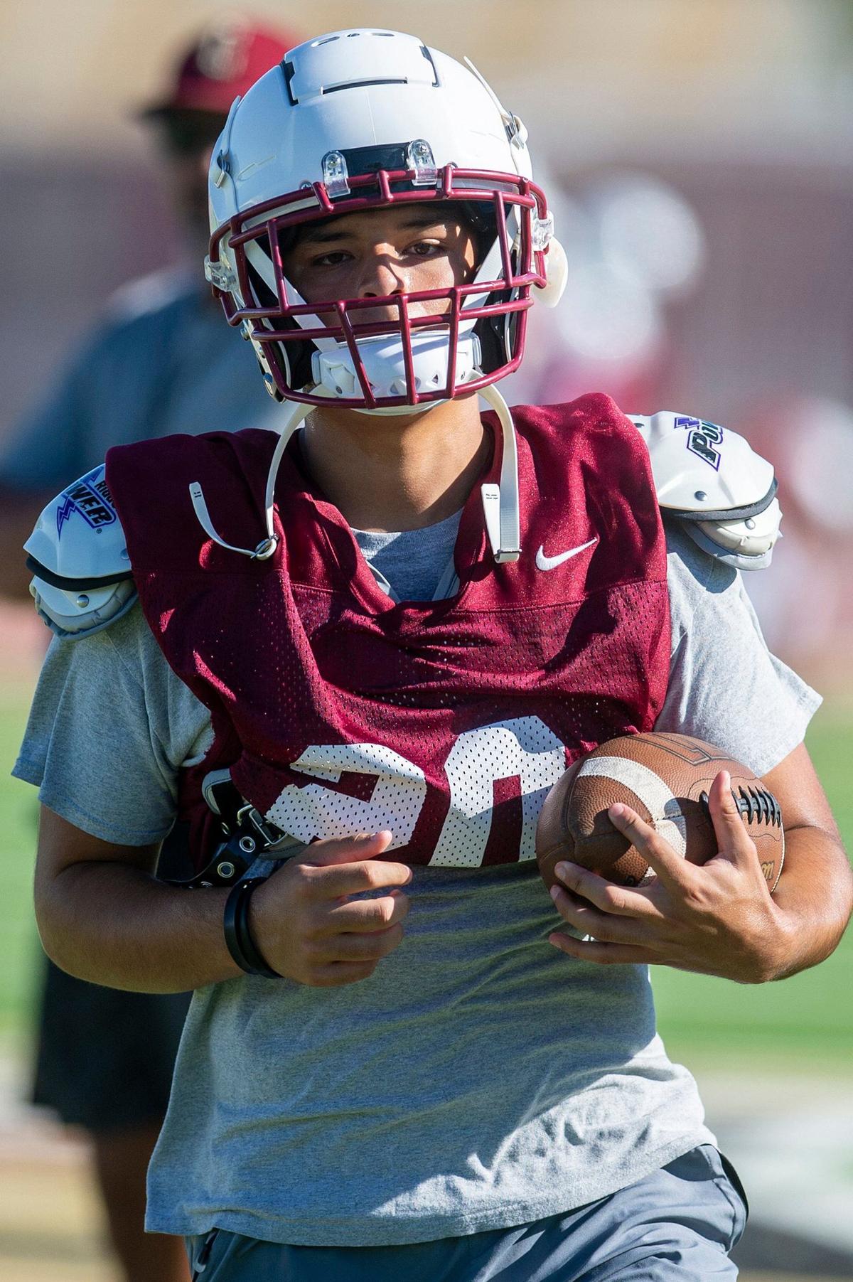 Dominic Gonzalez sprints upfield after catching a pass during football practice at Golden Valley High School in Merced, Calif., on Tuesday, Aug. 20, 2024.