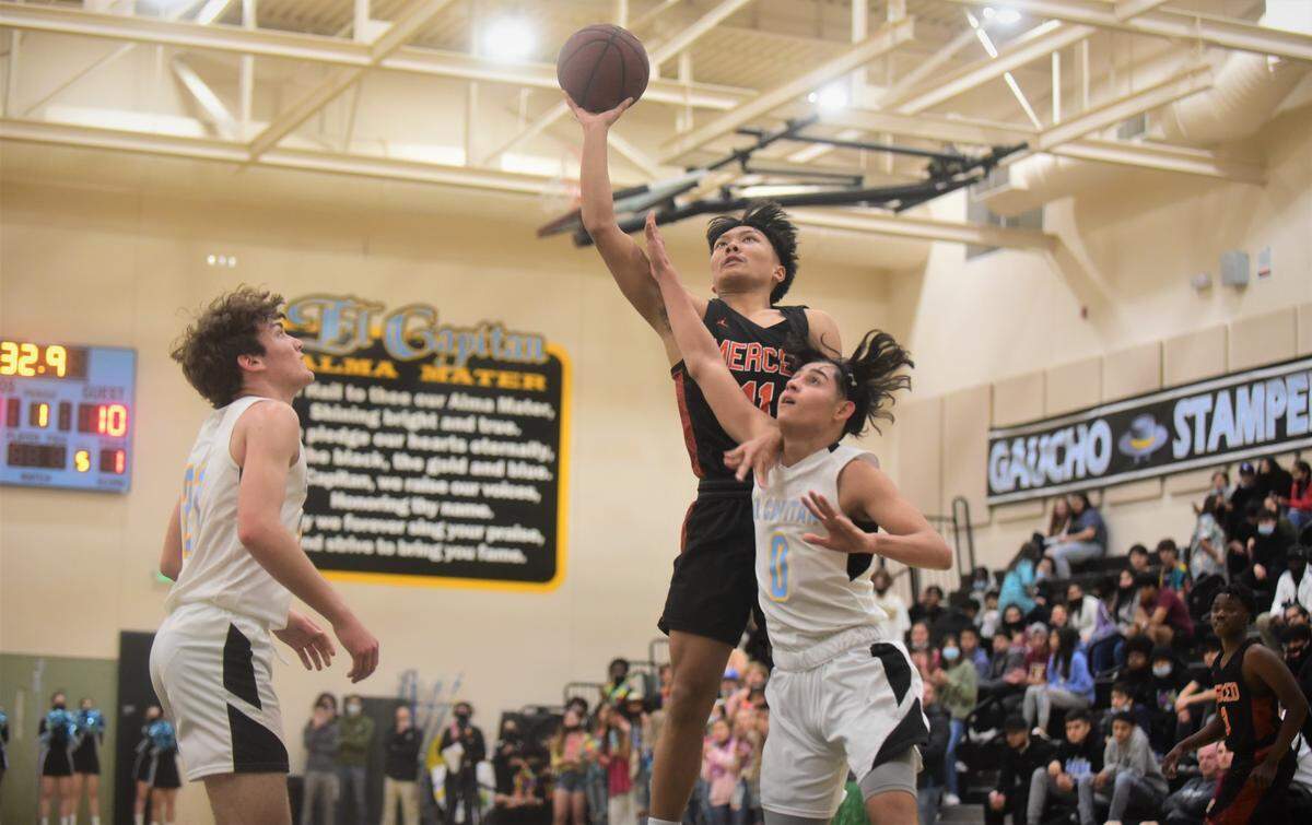 Merced High seior Gabe Celzo (11) goes up for a shot against El Capitan senior Edrian Figueroa (0) during a game at El Capitan High School on Monday, Feb. 7, 2022.