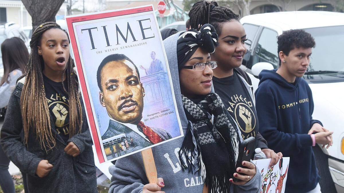Pacheco High School students carry signs and march from Los Banos City Hall to Bethel Community Church Monday, Jan. 20, 2020 as part of the Martin Luther King Jr. annual celebration.