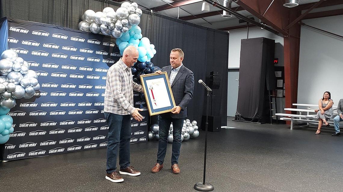 Carlos Vieira, left, is presented with a framed State Resolution by Assemblyman Adam Gray, D-Merced, right, recognizing the Carlos Vieira Foundation as the Non-Profit of the Year for Assembly District 21 at the 51Fifty Fitness Center in Livingston, Calif., on Tuesday, Aug. 9, 2022. Image courtesy of the office of Adam Gray.