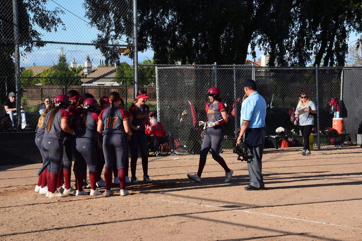 Golden Valley senior Marissa Bertuccio is greeted at home plate by her teammates after her second home run against Merced on Friday, April 5, 2019 at Merced High in Merced, Calif.