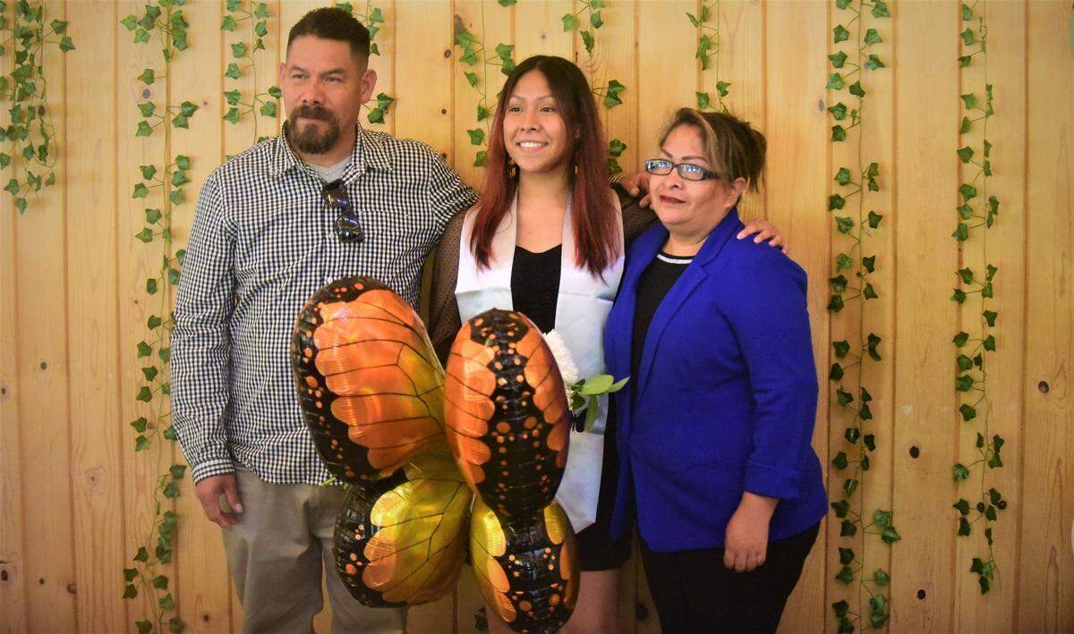 UC Merced student Beatriz Lopez poses for photos with her parents during a celebration recognizing UC Merced undocumented students who are graduating this weekend on Friday, May 13, 2022 at UC Merced in Merced, Calif.