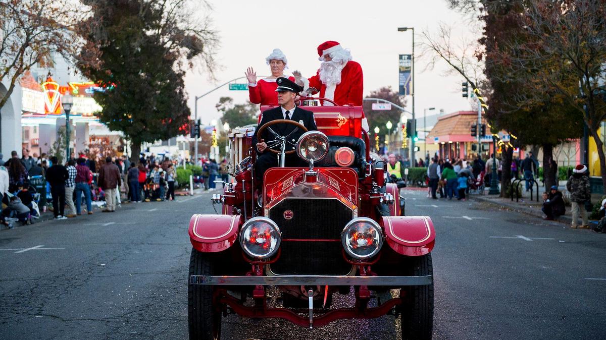 Santa Claus and Mrs. Claus wave to children from a classic fire truck during the 22nd annual Merced Hometown Christmas Parade presented by the Active 20-30 Club of Merced, in downtown Merced, Calif., on Saturday, Dec. 3, 2016.