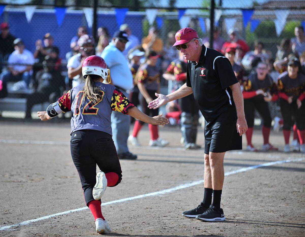 Oakdale coach Larry Loger congratulates senior Brittany Bye on a home run during the Mustangs’ 3-2 win over Golden Valley on Thursday, May 23, 2019.