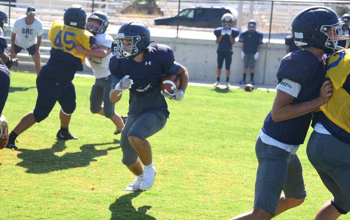 Stone Ridge Christian senior running back Luke Agueda runs the ball during practice on Wednesday, Aug. 7, 2024.
