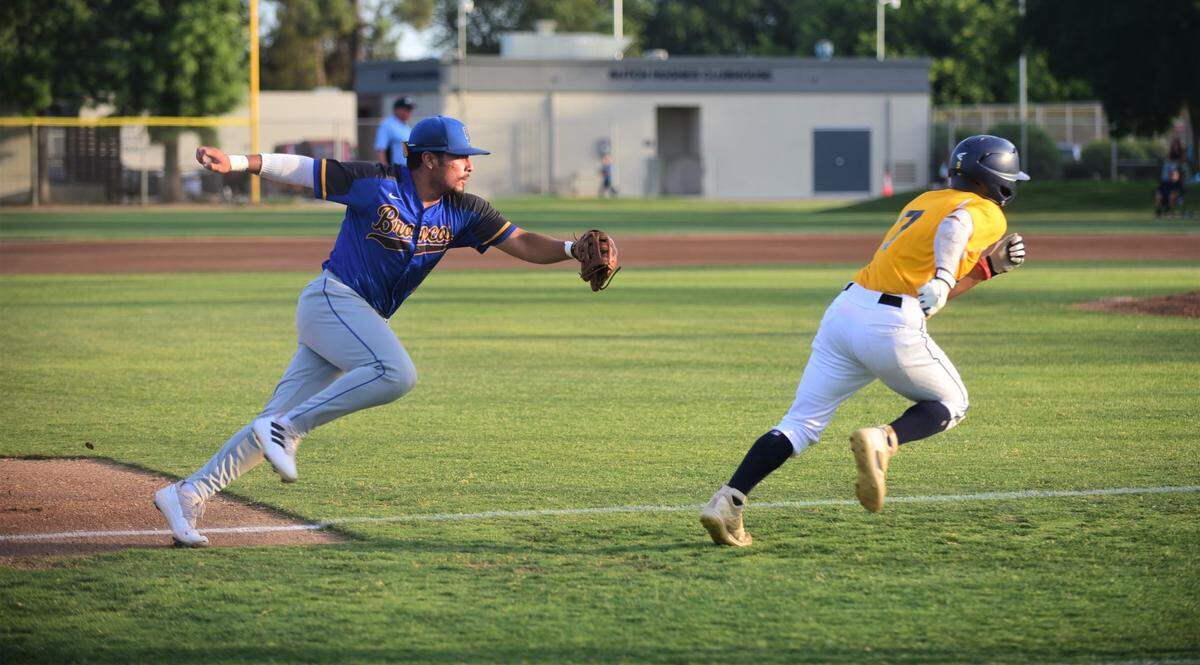 Merced County third baseman Isac Mandujano tries to run down Stanislaus County’s Felix Daclan in the first inning of the County Clash All-Star Game at Merced College on Saturday, June 17, 2023.