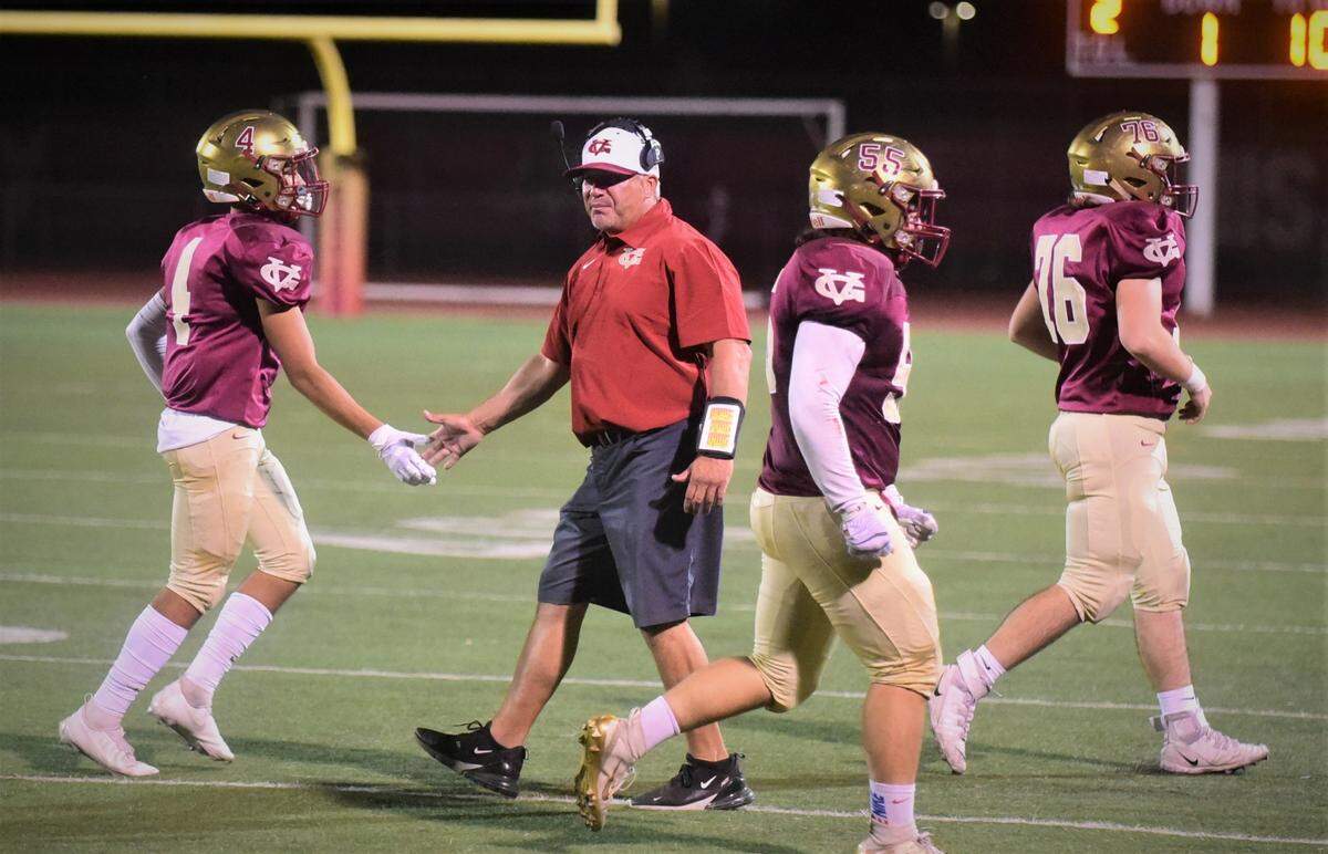 Golden Valley head coach Rick Martinez greets some of the Cougars defensive players as they come off the field during a 40-14 win over Chowchilla on Friday, Sept. 3, 2021 at Veterans Stadium in Merced, Calif.