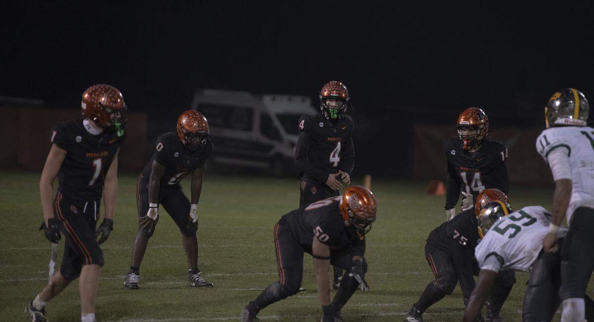 Merced quarterback Vicente Cortez surveys the defense before a snap against Vanden during a Division III playoff matchup on Friday, Nov. 14, 2025, in Merced. Cortez threw three touchdowns in the Bears’ 26-25 loss.