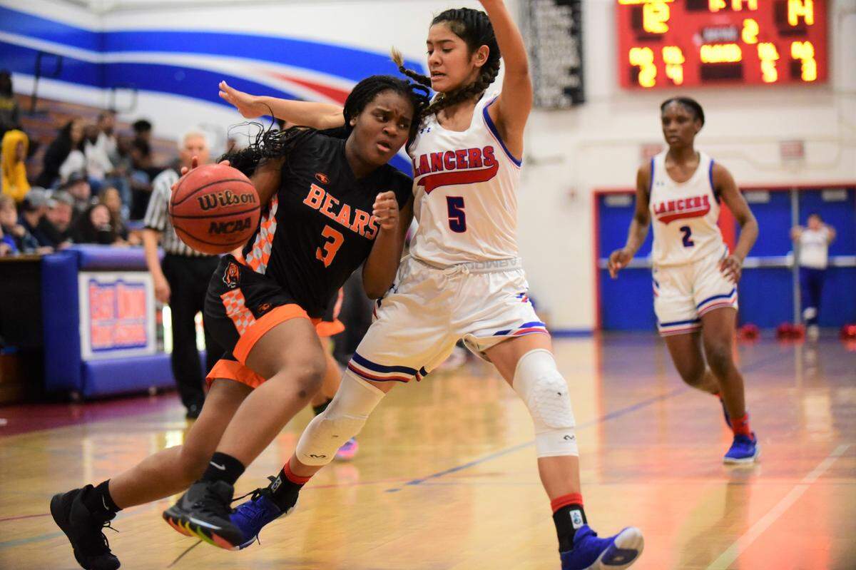 Merced High senior Janessa Jones tries to drive to the basket against East Union sophomore Lauren Pablo during a playoff game on Thursday, Feb. 20, 2020.