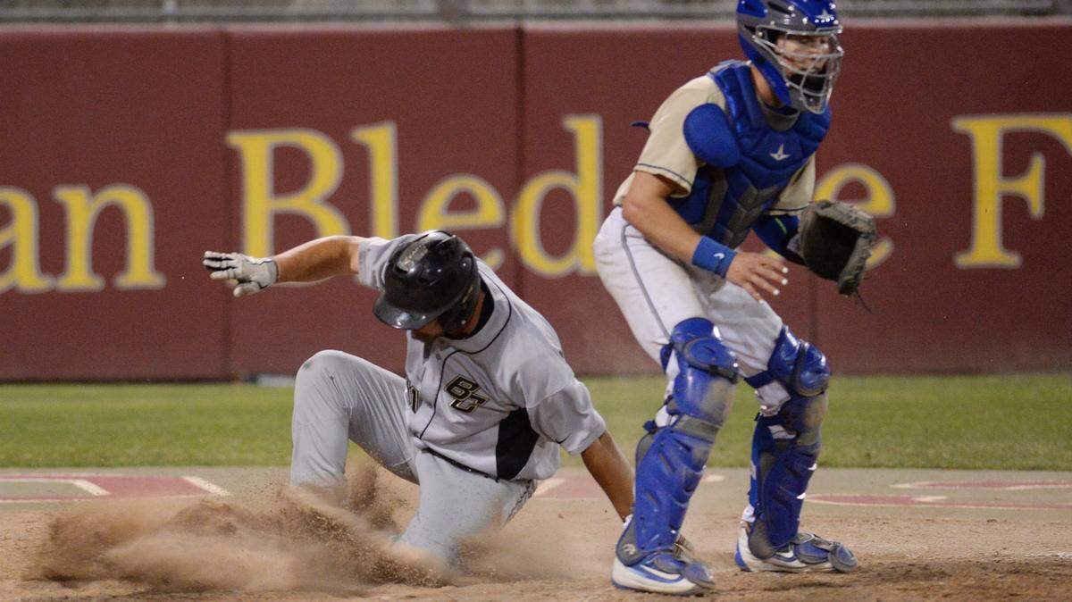 Clovis High catcher Darrien Miller, right, waits for the throw as Buhach Colony’s 	Kadon Floro slides past home for a run during the championship game of the Fresno Easter Classic at Clovis West on Wednesday, April 17, 2019. 