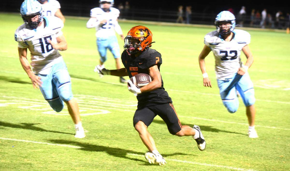 Merced High running back Adarius Morales-Saetern (2) runs the ball during a game against Downey on Friday, Sept. 6, 2024.