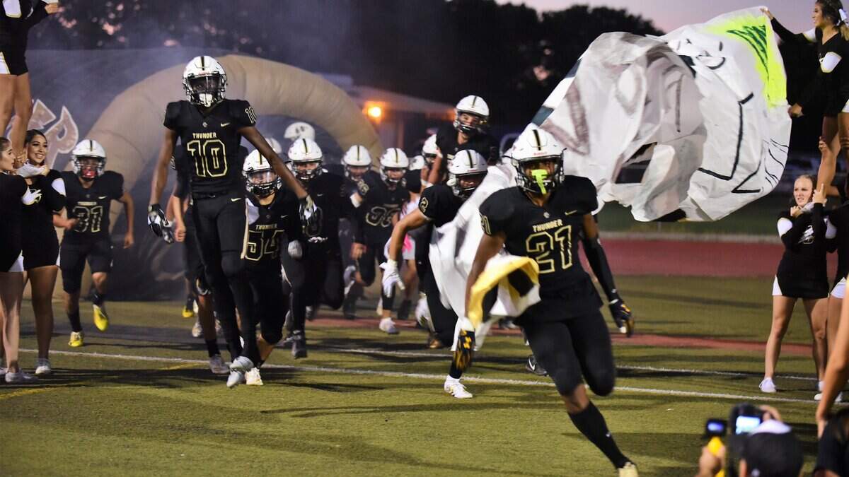 Trey Paster (21) leads Buhach Colony onto the field on Friday, Aug. 30 against Tracy at Dave Hone Stadium in Atwater, Calif. 