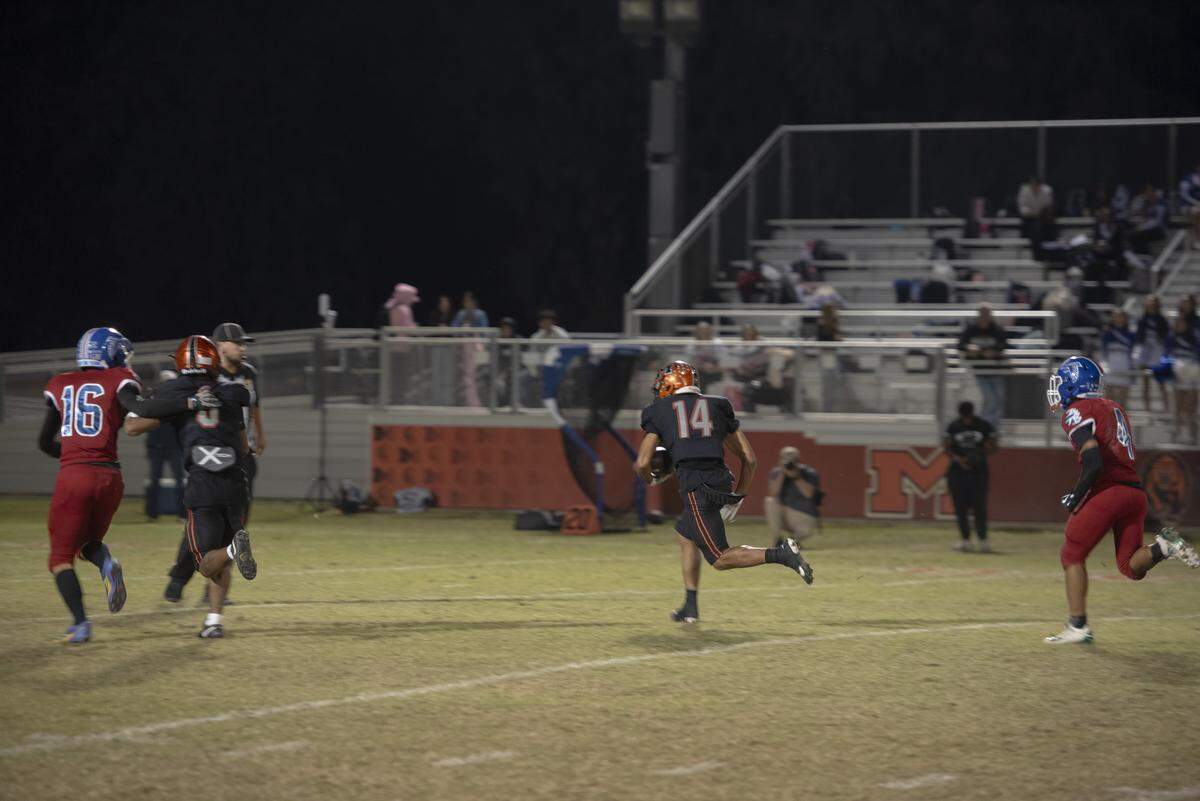 Merced High wide receiver Israel Rodas (14) sprints down the sideline for a long touchdown reception during the first half of the Bears’ 49-14 win over Atwater at Merced High on Friday, Oct. 24, 2025.