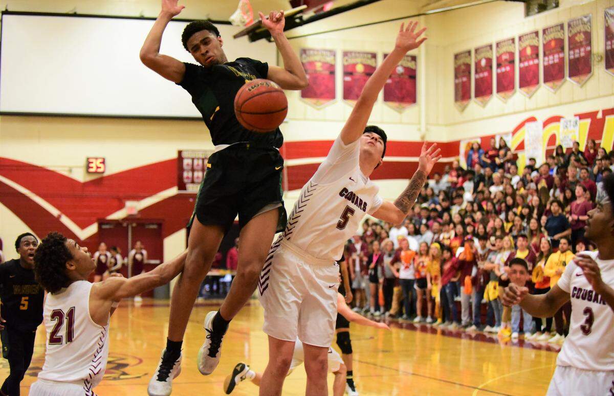 Takai Emerson-Hardy comes down after dunking a ball against Golden Valley during the Sac-Joaquin Section Division III semifinal game in Merced, Calif. on Tuesday, Feb. 25, 2020