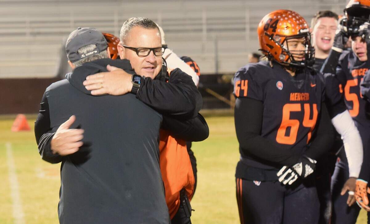 Merced High head coach Rob Scheidt receives a congratulatory hug from his brother Rick Scheidt after picking up his 200th career win with a 41-35 playoff victory against Rio Americano on Friday, Nov. 8, 2024 at Merced High School.