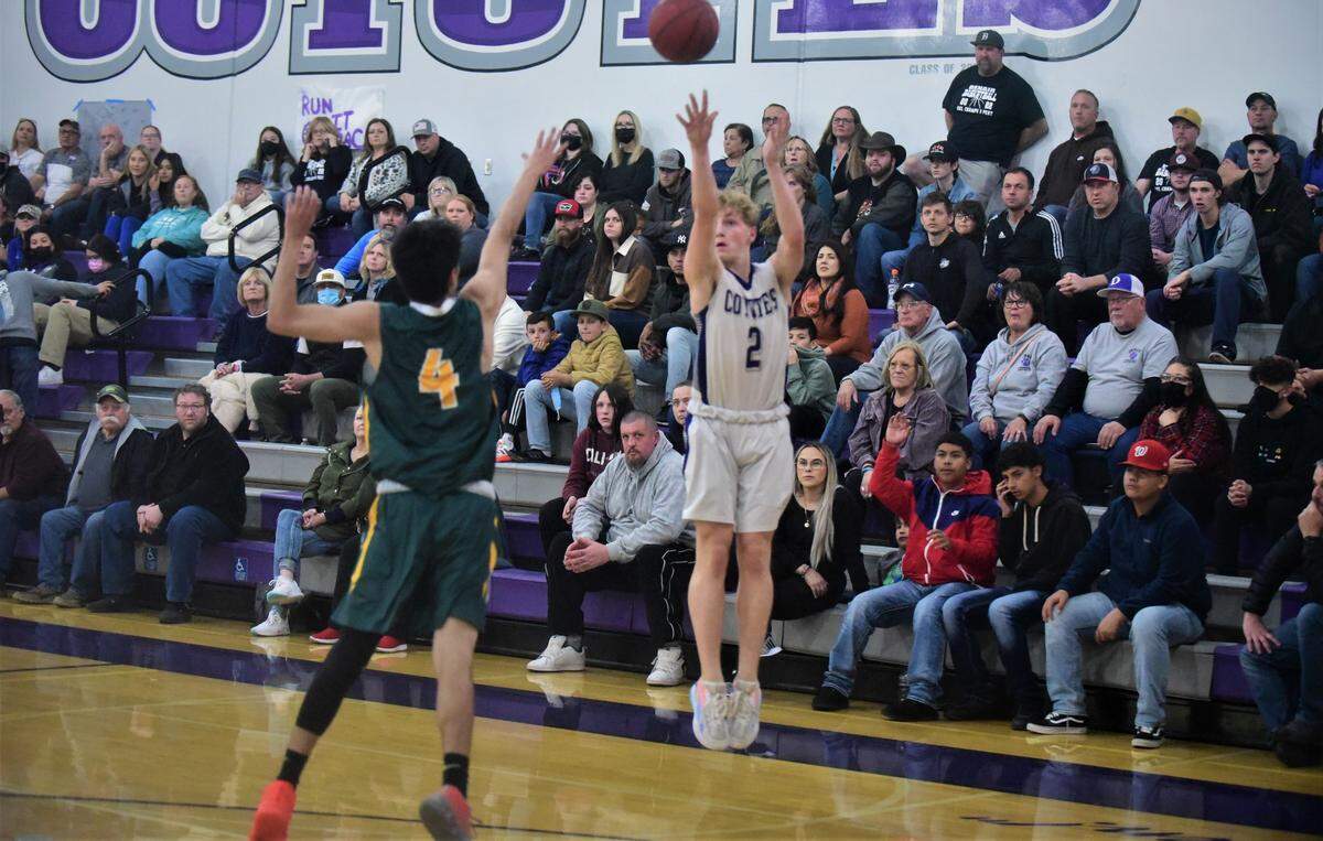 Denair High senior Cooper Feldman (2) takes a shot at Mariposa High senior Lance Dondero closes out during a playoff game on Wednesday, Feb. 23, 2022 at Denair High School.