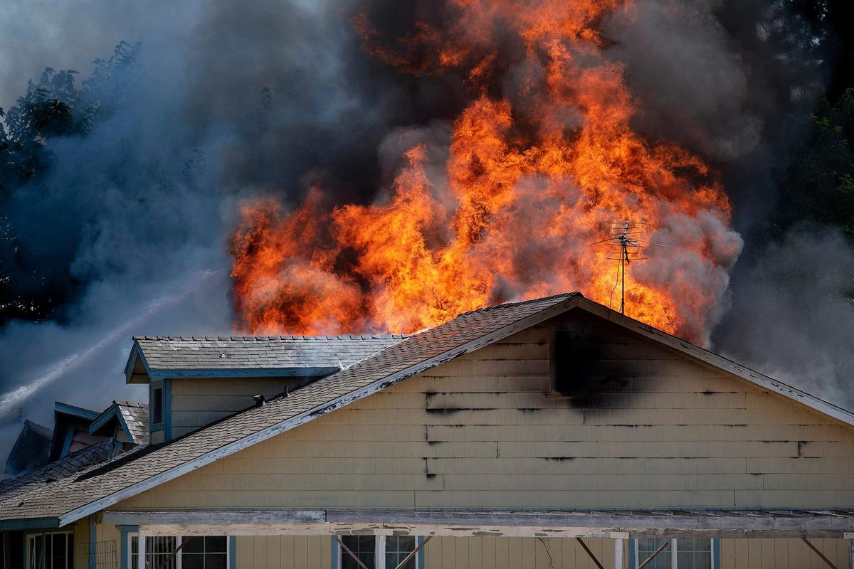 Cal Fire Merced County firefighters and City of Merced firefighters battle a structure fire which damaged two homes in the 1800 block of Dunn Road in Merced County, Calif., on Wednesday, Aug. 23, 2023. Fire officials said the cause of the fire is under investigation.