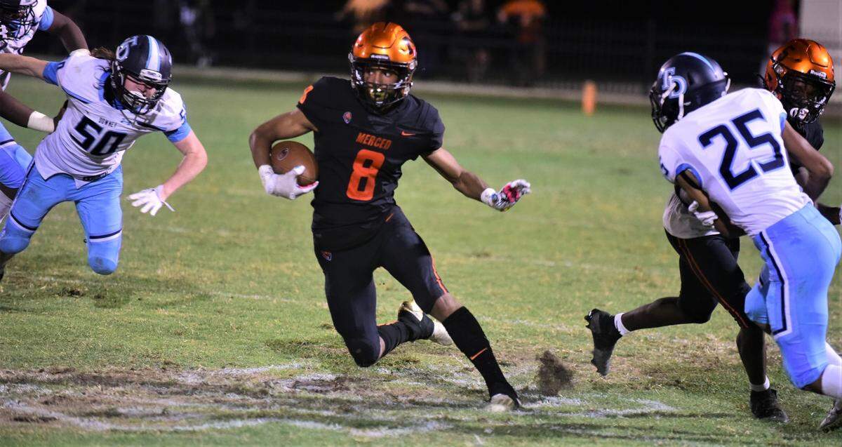 Merced High School receiver Enoch Evans run the ball against Downey during a game on Friday, Sept. 2, 2022 at Cathie Hostetler Stadium.