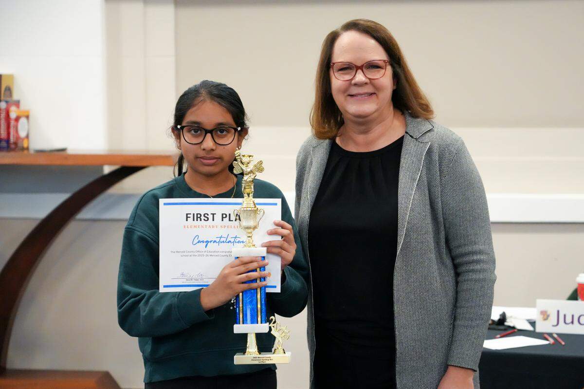 Akshara Thummala stands holding her first place certificate and trophy with Merced County Office of Education Director of Human Resources Stacy Shasky.