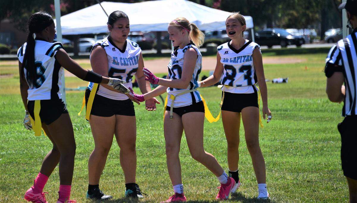 El Capitan High School players celebrate after a touchdown during a girls flag football game against Mariposa on Saturday, Aug. 19, 2023 at Merced High School in Merced, Calif.
