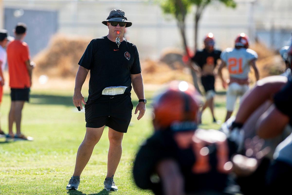 Merced High School football coach Rob Scheidt looks on during practice at Merced High School in Merced, Calif., on Monday, Aug. 19, 2024.