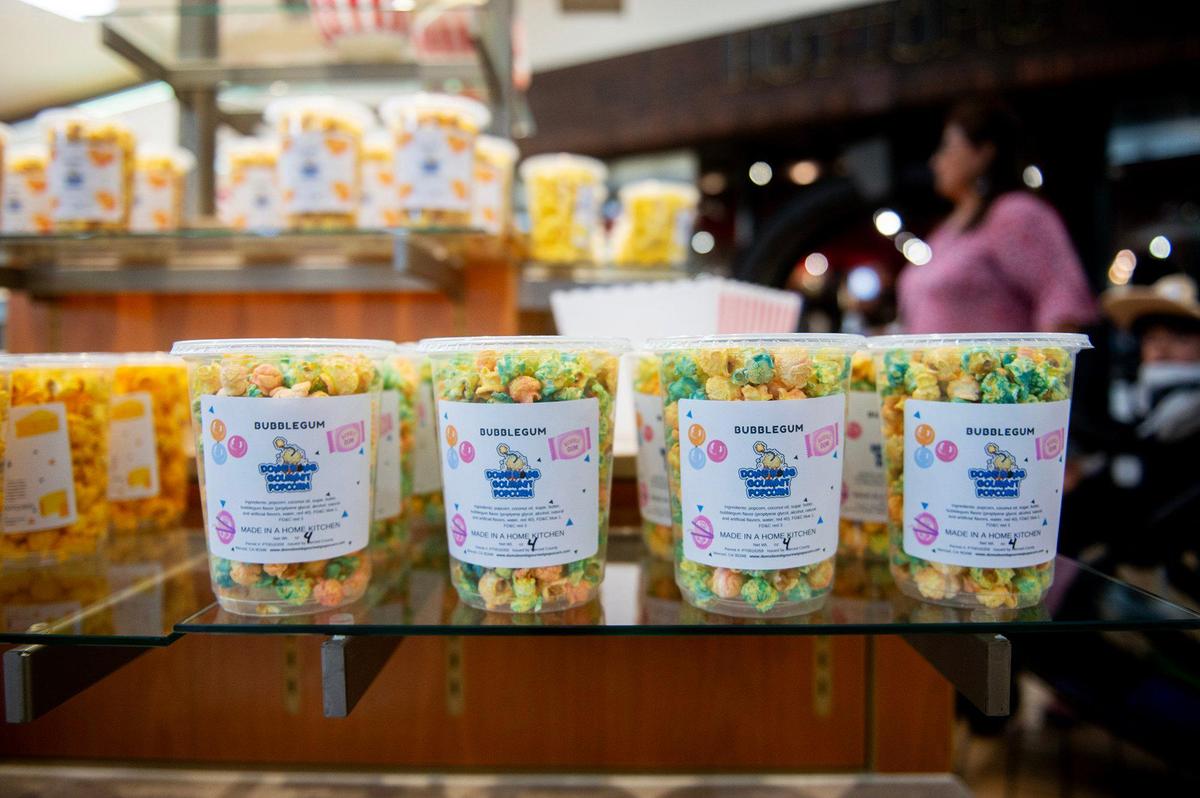 Various flavors of popcorn for sale during the grand opening of Dom’s Bomb Gourmet Popcorn inside the Marketplace at Merced in Merced, Calif., on Thursday, May 1, 2025. The kiosk offers unique gourmet popcorn flavors created by Merced resident Dominique Pruitt.