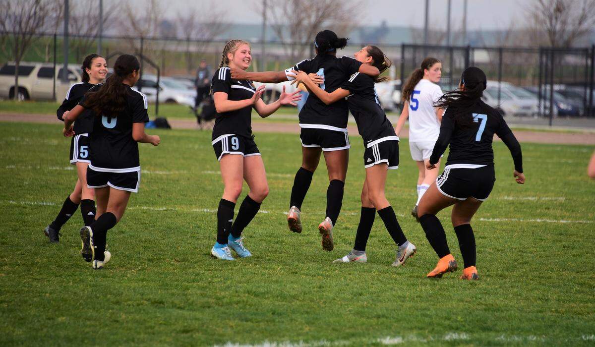 El Capitan players celebrate a goal by Haley Espinoza (1) in the first half during a 3-2 playoff win over Kimball on Friday, Feb. 21, 2020 at El Capitan High School.