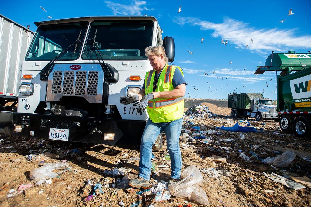 Merced Refuse Equipment Operator Kristie Light, 56, empties refuse from the truck at the landfill in Merced Calif. on Thursday, Oct. 24, 2024. According to Light who previously drove commercial trucks across parts of the country and would routinely be gone for 70-80 hours a week, her current job with the city allows her to spend more time at home. “It’s nice to go to work and like your job,” said Light.