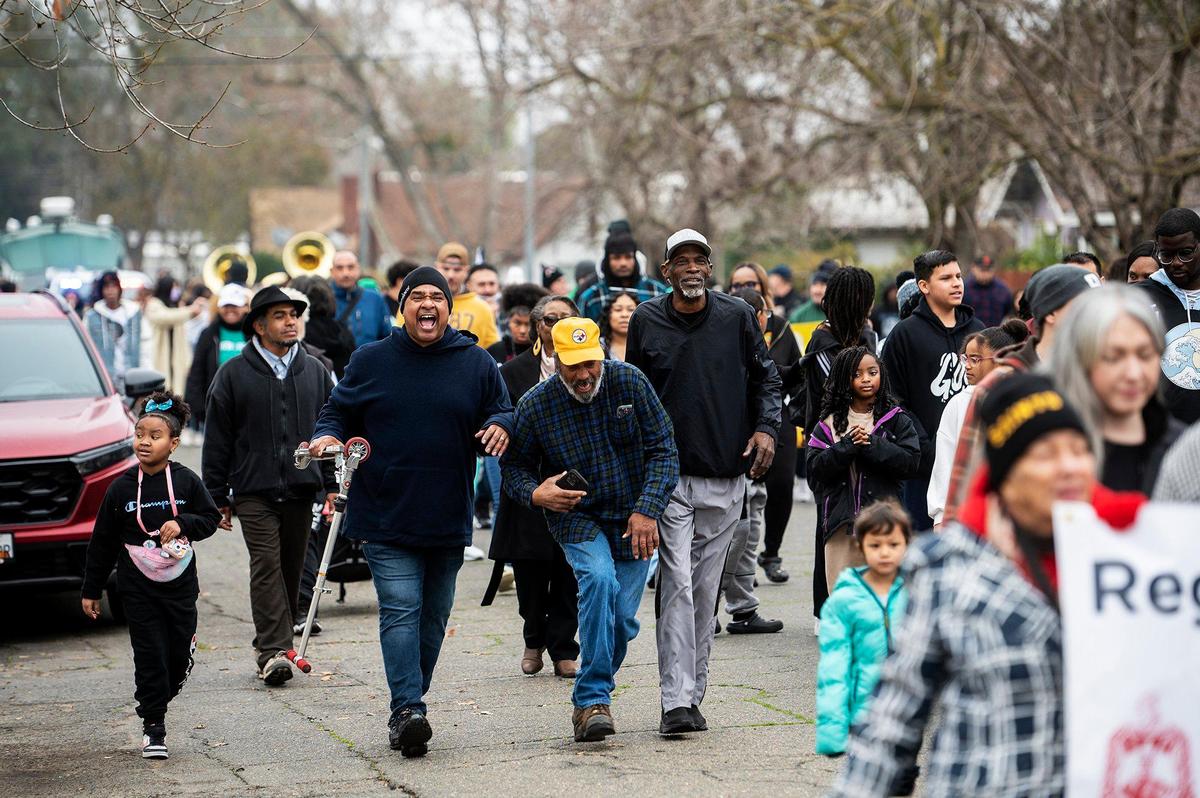 Marchers walk along Martin Luther King Jr. Way during the annual Peace and Unity March to honor the legacy of late civil rights leader Rev. Dr. Martin Luther King Jr. in Merced, Calif., on Monday, Jan 15, 2024.