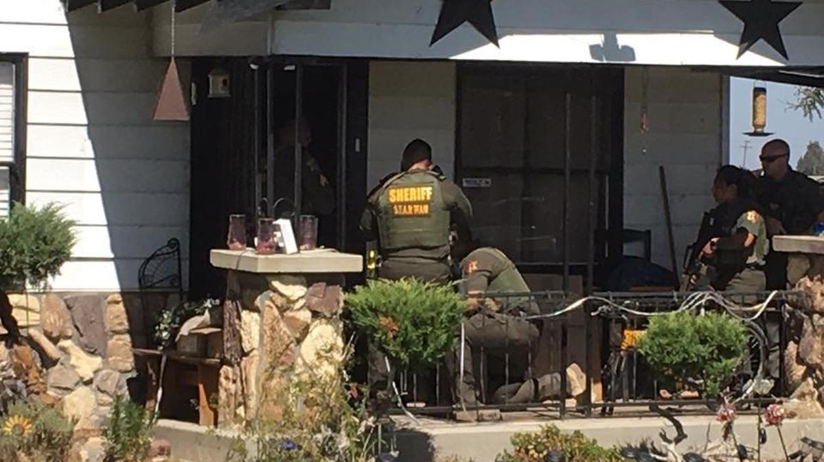 Deputies are shown serving the warrants on Thursday. Photo courtesy of the Merced County Sheriff’s Office.