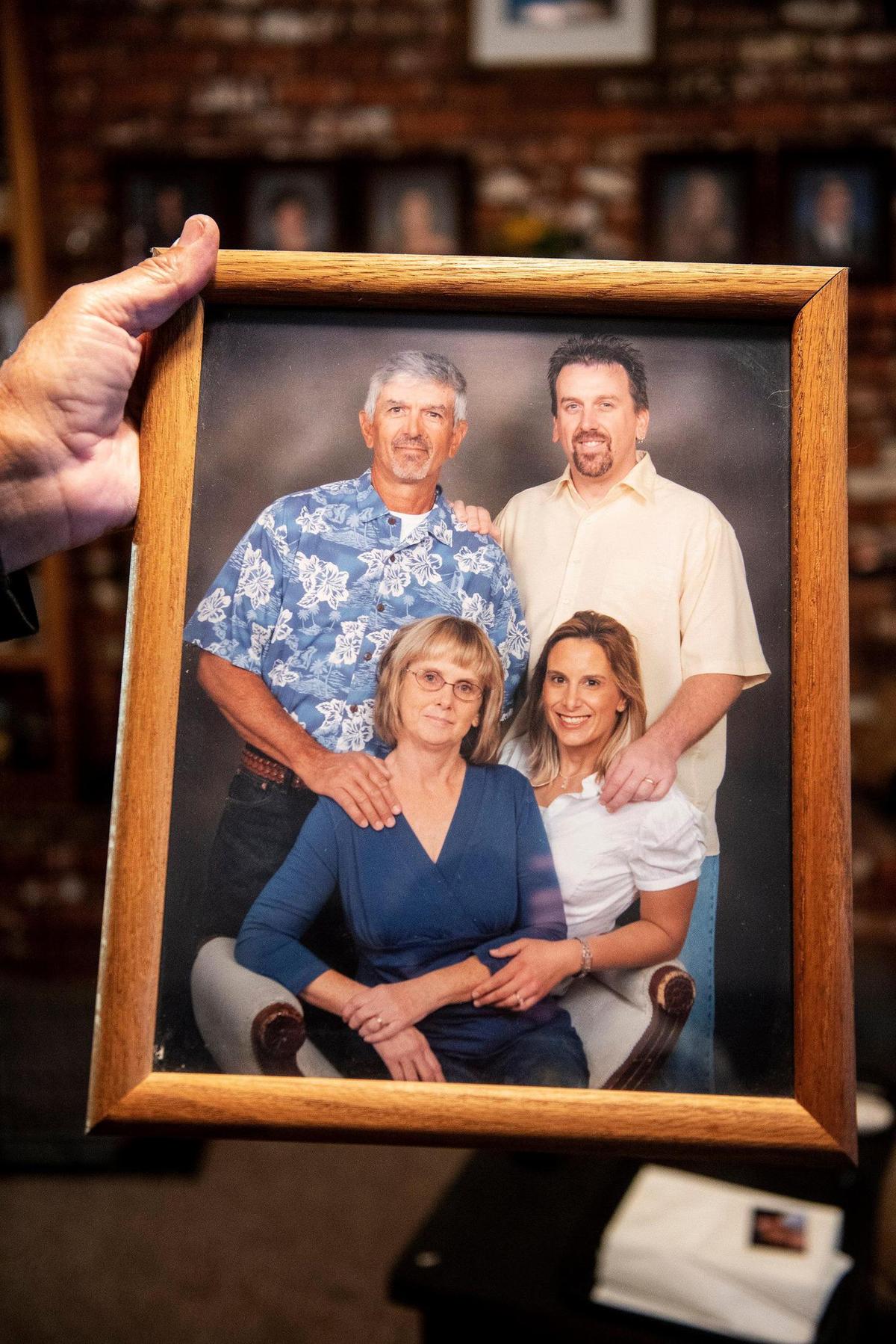 Bob Edwards, 76, holds a photo of he and wife Billie Edwards, with their children Rob Edwards and Michelle Elissiry, at their home in Atwater, Calif., on Thursday, Nov. 3, 2022. Family members said Edwards, 73, and her sister Carolyn Rose, 76, were walking along East Juniper Avenue on Nov. 2, when they were struck and killed by a vehicle. Authorities said the vehicle was traveling westbound on East Juniper Avenue when it left the roadway striking the women and a light pole.