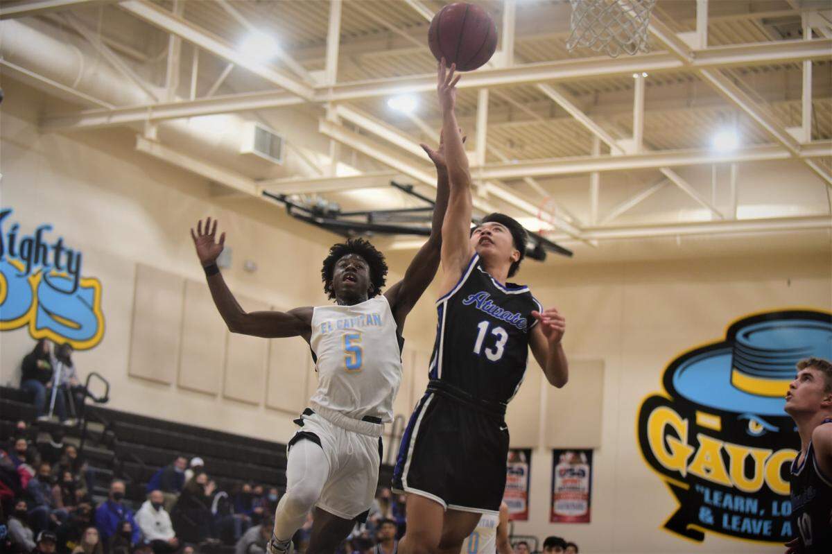 Atwater High’s Lucas Nguyen (13) goes up for a shot against El Capitan High senior Gregory Mack (5) during a game at the Stable Center at El Capitan High School on Friday, Jan. 14, 2022 in Merced, Calif.