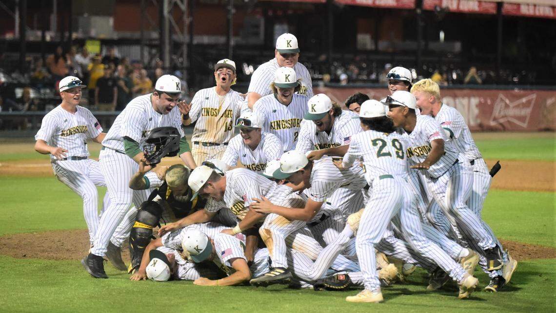 The Kingsburg High School baseball team dog piles after winning the Central Section Division III Valley Championship with a 7-5 victory over Dos Palos on Thursday night at Valley Strong Ballpark in Visalia, Calif.