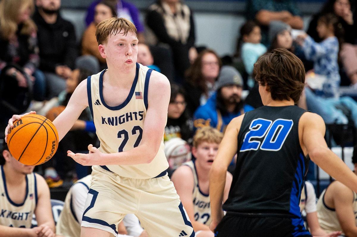 Stone Ridge Christian freshman Tyler Mccabe (22) looks to pass the ball during a CIF Sac-Joaquin Section Division 6 playoff game against Sacramento Waldorf at Stone Ridge Christian High School in Merced, Calif., on Tuesday, Feb. 20, 2024. The Knights beat the Wave 50-37.