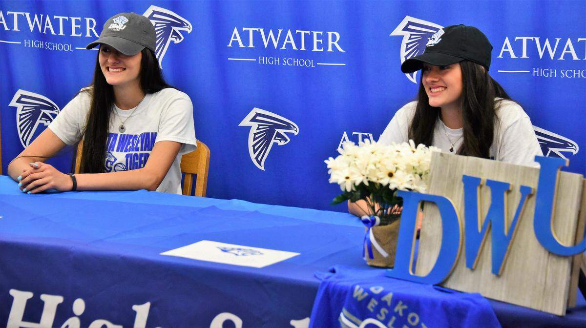 Atwater High twin sisters Lexi (left) and Kelsey Valencia celebrated signing a basketball scholarship with Dakota Wesleyan University with a large crowd in the school library on Tuesday, April 30, 2019 at Atwater High in Atwater, Calif.