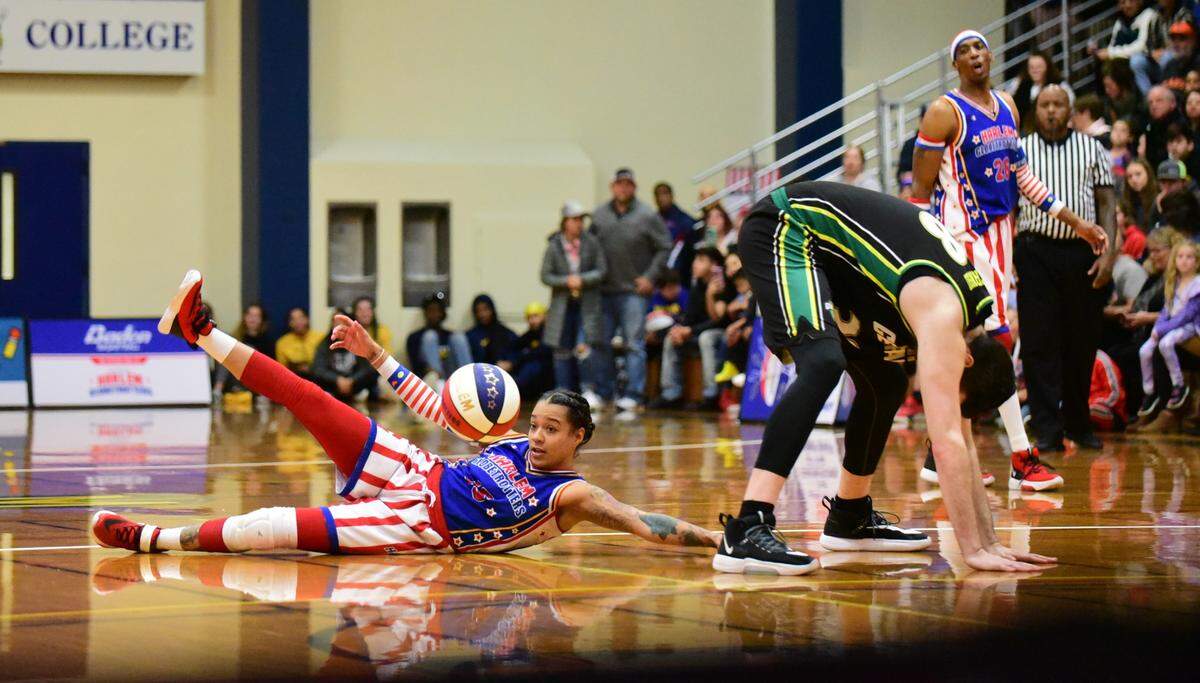 Harlem Globetrotters player Ice Hrynko slides under the legs of a Washington Generals player during a show on Thursday, Jan. 16, 2020 at Merced College. 