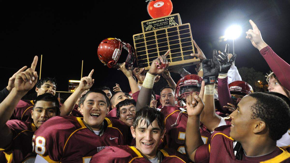 GENE LIEB/glieb@losbanosenterprise.com
Los Banos players hoist the Morning Star Crosstown Clash trophy following a 10-6 win over Pacheco Friday (Nov. 2, 2012) at Loftin Stadium.
