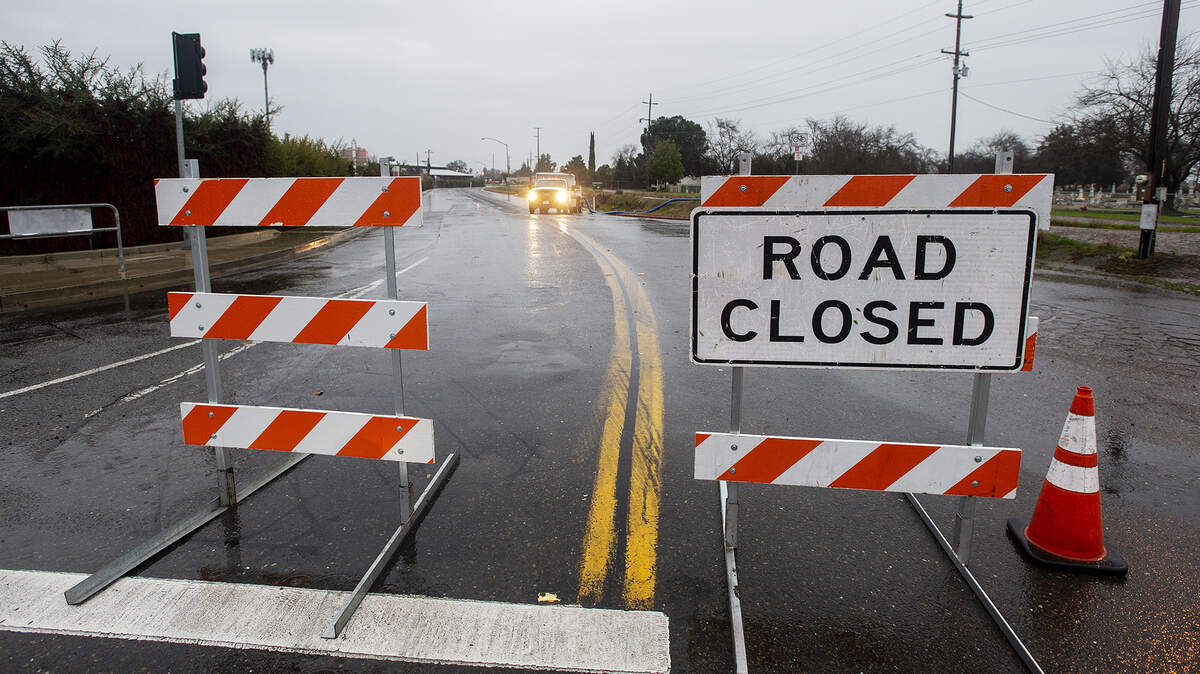 A section of West Childs Avenue between G Street and Martin Luther King Jr. Way is closed Wednesday evening due to flooding caused by rain showers in Merced, Calif., on Jan. 27, 2021.