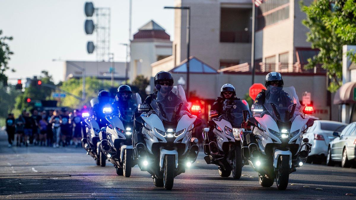 Merced Police Department officers lead runners along West 18th Street during the annual Law Enforcement Torch Run for Special Olympics Northern California in Merced, Calif., on Wednesday, June 25, 2025.