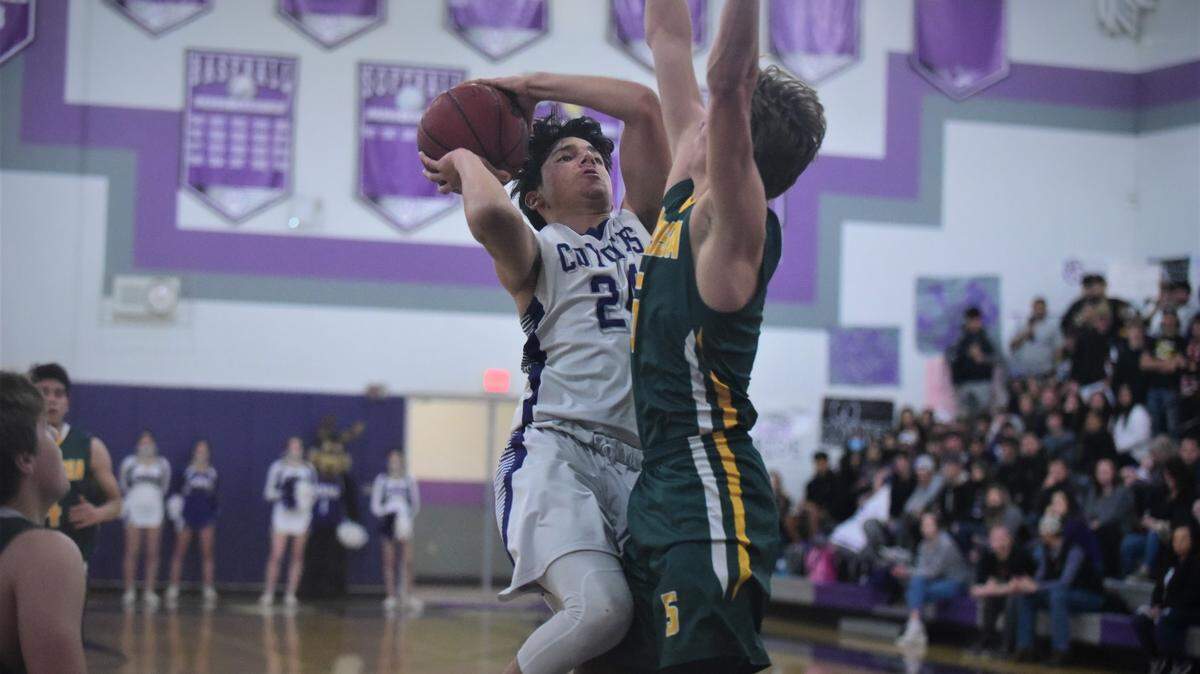 Denair High junior Izaiahs Plasencia (24) drives to the basket against Mariposa High junior Johann Hill-Zeck (5) during a playoff game on Wednesday, Feb. 23, 2022 at Denair High School.