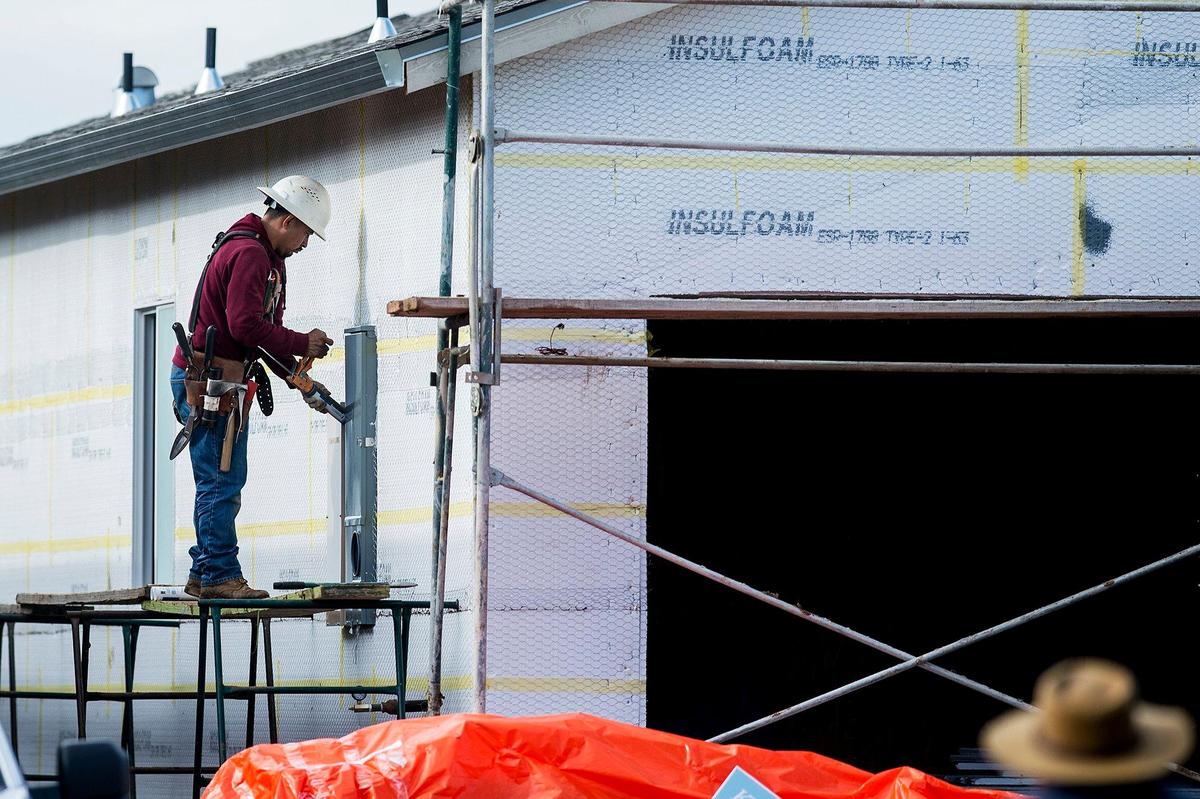 Construction crews work to build new homes on Freemark Avenue in The Meadows at Bellevue Ranch West neighborhood in Merced, Calif., on Friday, Jan. 11, 2019.